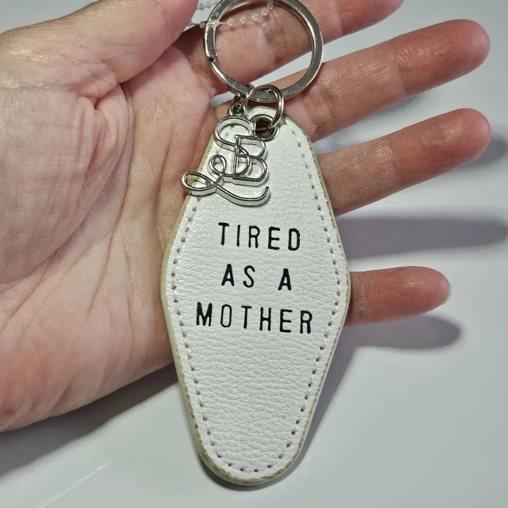 Santa Barbara Design Studio Silver Tone White Leather Tired As A Mother Keychain